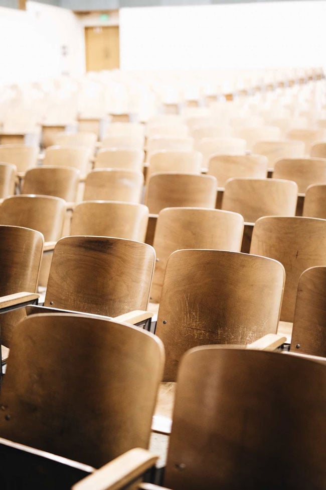 Rows of empty wooden chairs