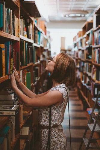 a student looks for a library book