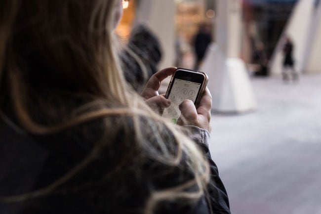 person texts on a smartphone