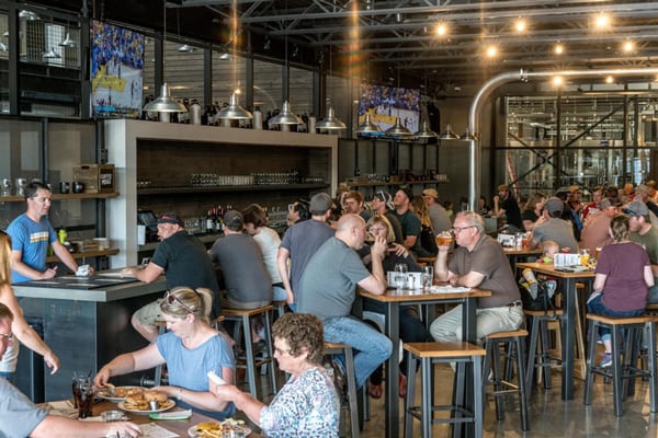 Inside of a busy brewery with restaurant waiting app