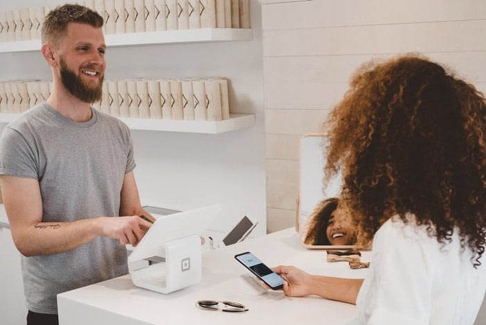 Woman receiving great customer service from a cashier