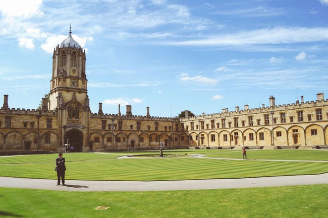 people stand in front of a university