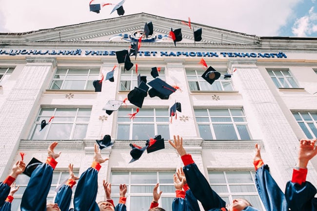 College graduates throw their caps