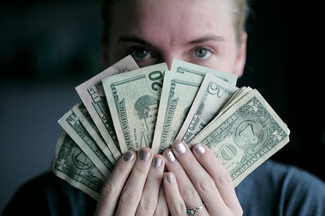young woman holds money