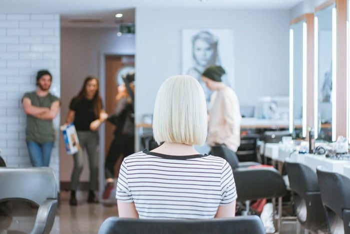 woman sitting in char in hair salon