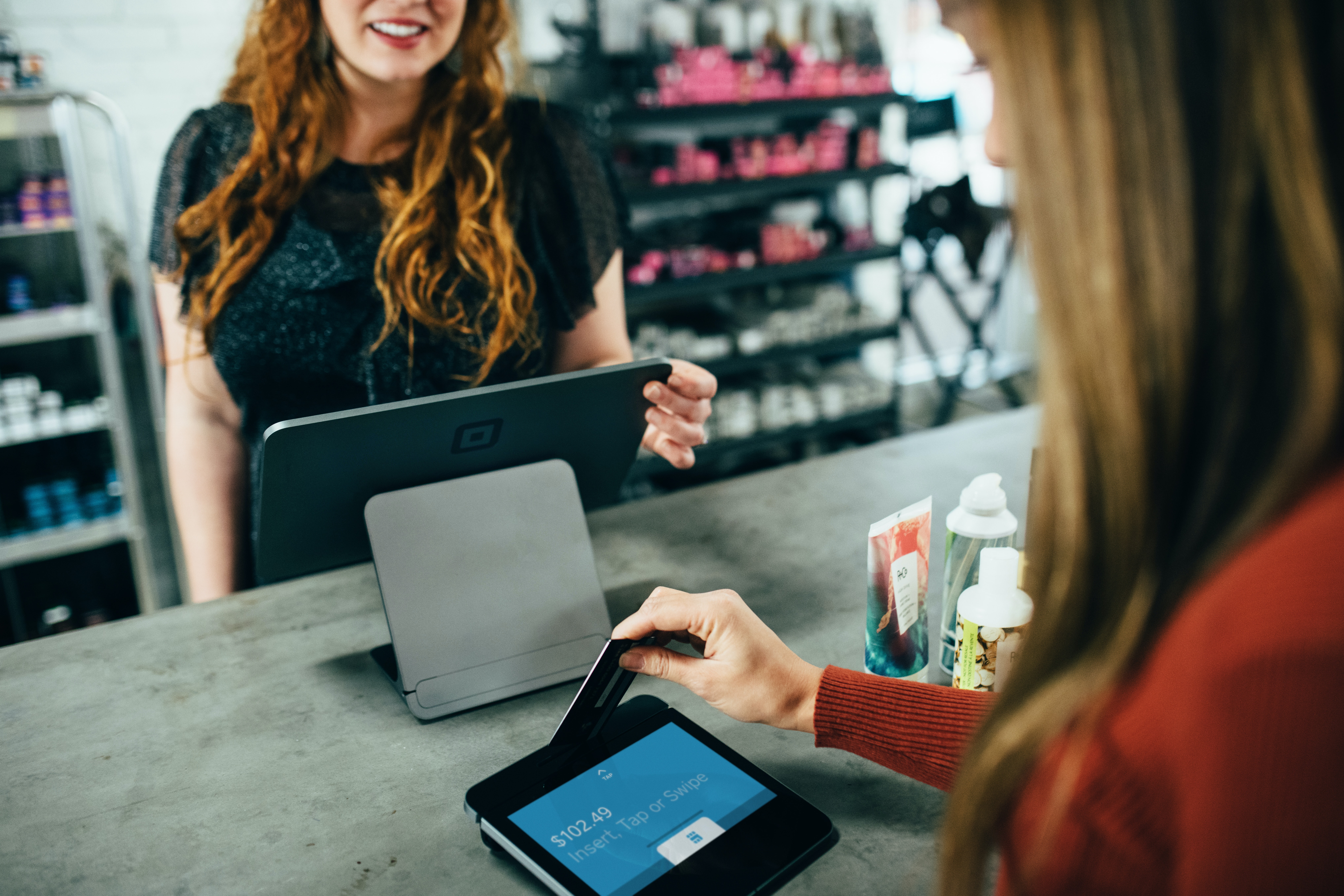 a woman buying items after having a positive shopping experience