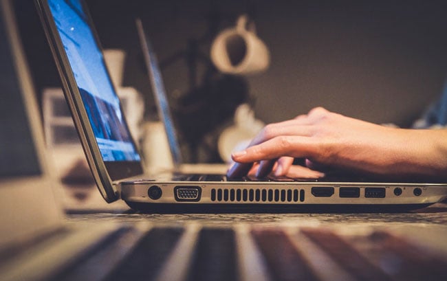 person typing on a laptop