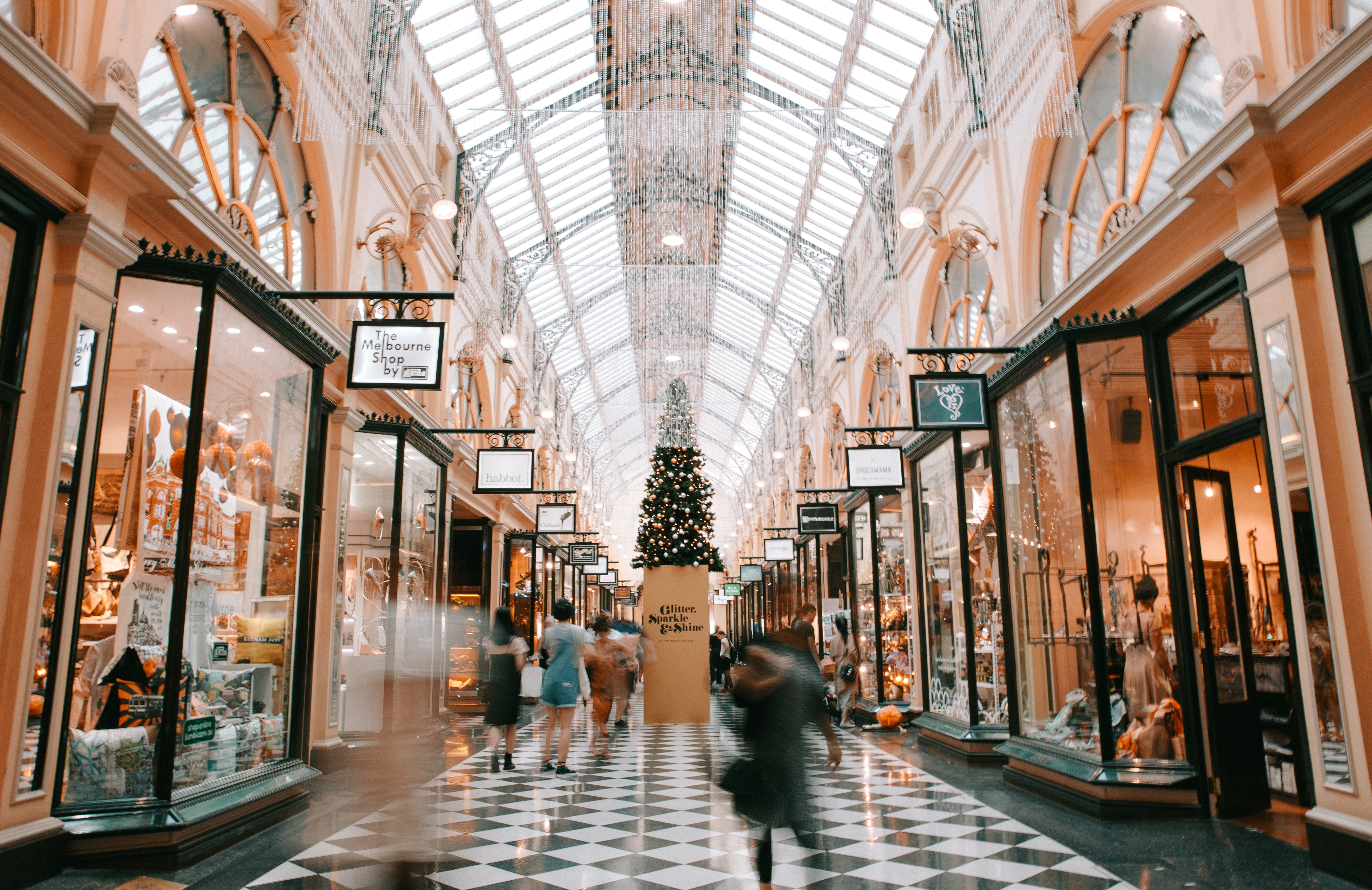 customers shopping in a mall decorated for the holiday shopping season
