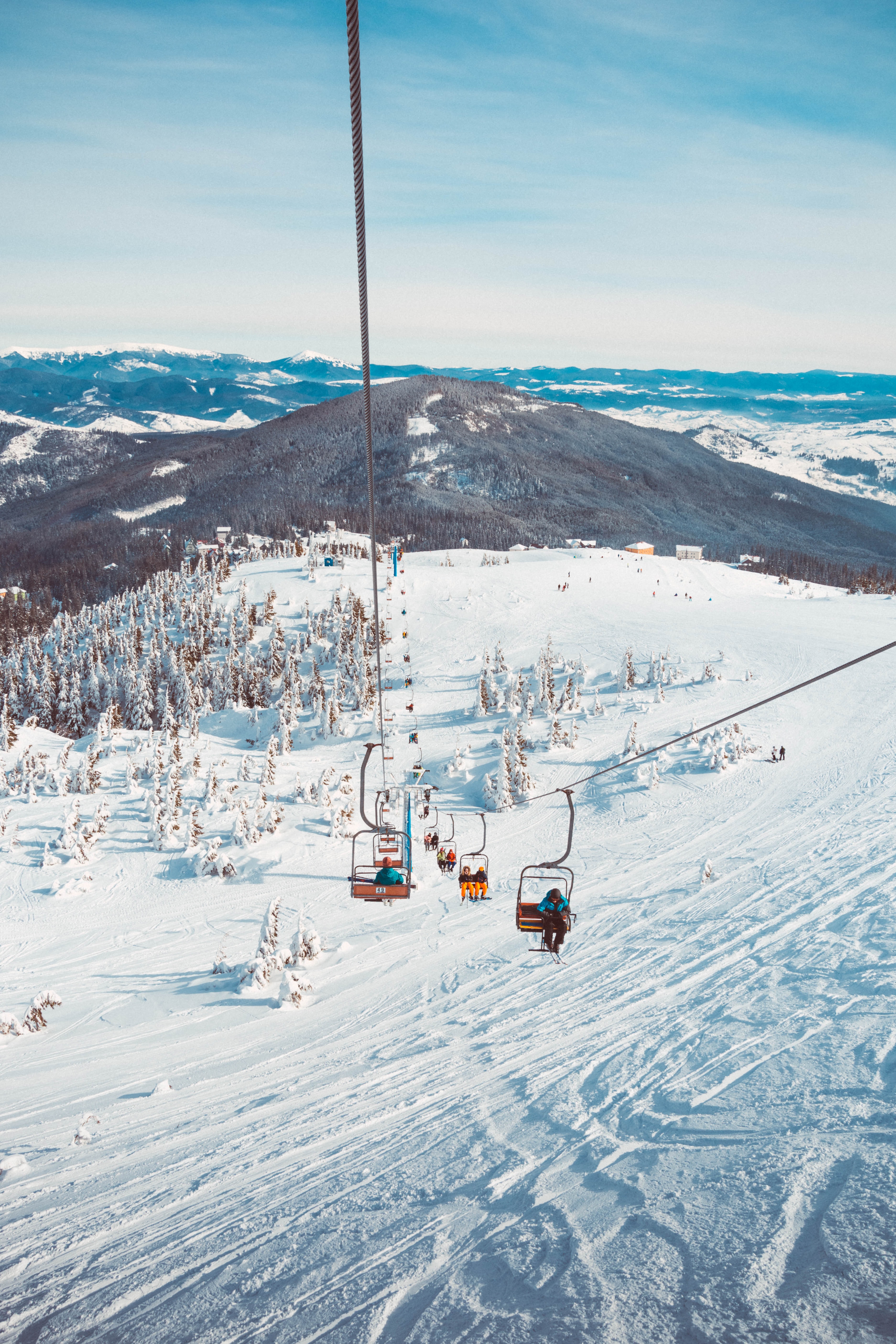 Ski lift going up a snowy mountain