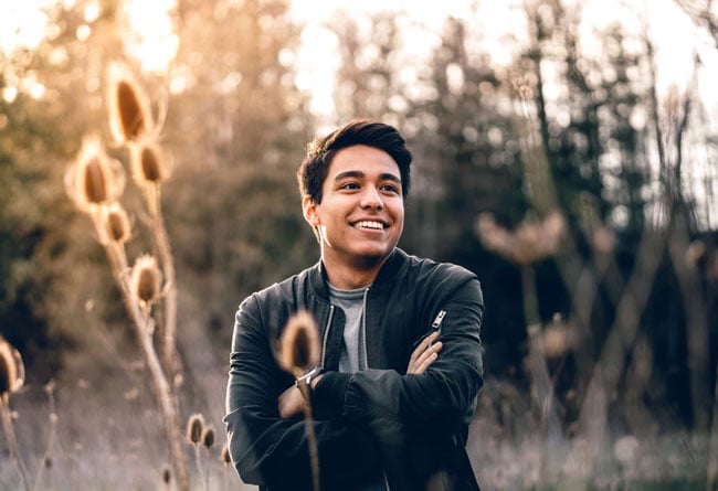 a man is smiling outside
