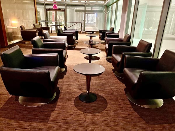 Empty waiting room with desks and brown chairs