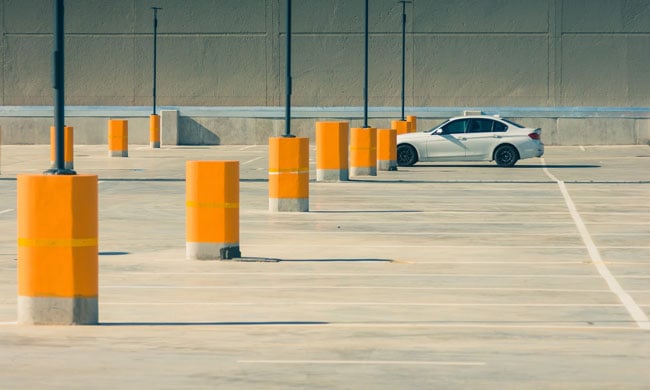 white car sitting in empty parking lot